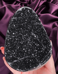 Black galaxy amethyst cutbase with sparkling druzy crystal surface and dark tones