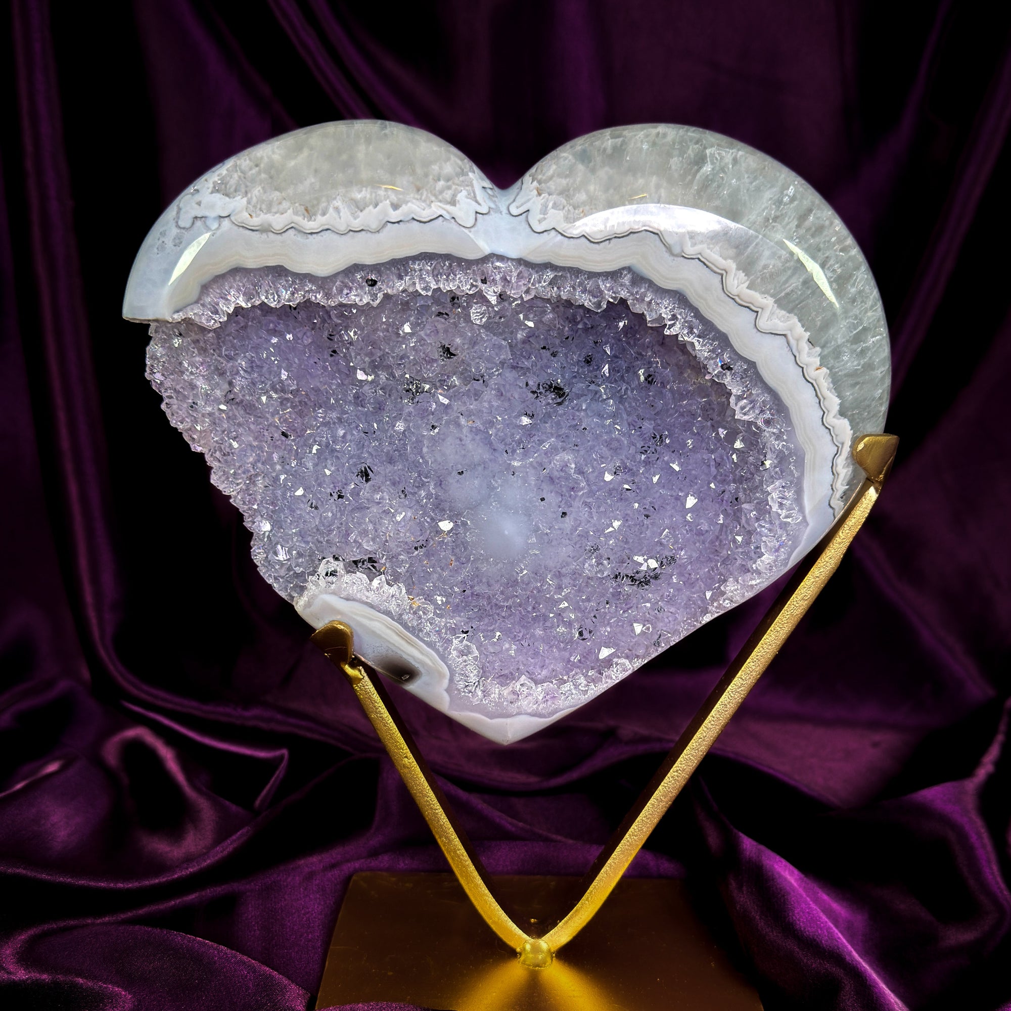 Heart-shaped druzy agate crystal on a gold stand 